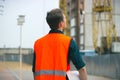 The engineer holding the white helmet safety at construction site with crane