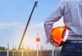 Engineer holding yellow safety helmet in building construction site Royalty Free Stock Photo