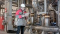 Engineer Inside Power Plant With Checklist