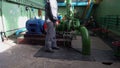 Engineer inspecting old water pump at factory