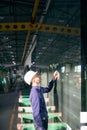 Engineer inspects glass in a production workshop