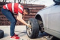 Engineer installing performance summer tires on grey car Royalty Free Stock Photo