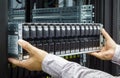 IT Engineer installs JBOD to rack in datacenter Royalty Free Stock Photo