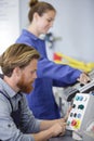 engineer instructing female apprentice on use cnc machine Royalty Free Stock Photo