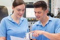 Engineer Instructing Female Apprentice On Use Of CNC Machine Royalty Free Stock Photo