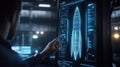 Engineer interacting with a large holographic touchscreen displaying a 3D wireframe model of an rocket