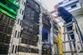 Engineer is laying and connecting the wires. A specialist stands on the ladder in the server room of the data center. Repair of