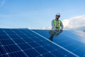 engineer looking at the camera smiling after installing solar panels, concept of renewable energy power, technician working on a Royalty Free Stock Photo
