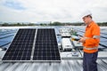 Engineer maintenance solar panel equipment on factory roof