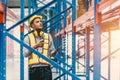 Engineer male checking steel metal construction warehouse shelves structure building