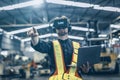 Engineer male using VR virtual reality technology in modern warehouse factory new innovation engineering Royalty Free Stock Photo