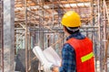Engineer man checking and planning project at construction site, Man holding blueprint selective focus on paper Royalty Free Stock Photo