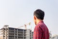 Engineer man checking and planning project at construction site, Man looking into the building site Royalty Free Stock Photo
