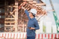 Engineer man checking project at construction site, Foreman in hardhat at the infrastructure building site Royalty Free Stock Photo
