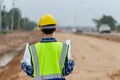 Engineer man checking project at site, Foreman worker with blueprints planning inspecting at road construction site Royalty Free Stock Photo