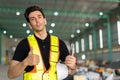 Engineer man hand like sign or factory worker wear safety helmet in warehouse site indoor Showing thumbs up happy smile.Good Royalty Free Stock Photo