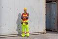 Engineer man in hard hat standing with arms crossed at container cargo Royalty Free Stock Photo