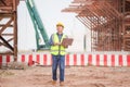 Engineer man with laptop at construction site, Foreman worker checking project in building site Royalty Free Stock Photo