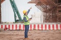 Engineer man with laptop at infrastructure construction site, Foreman worker checking project in building site Royalty Free Stock Photo