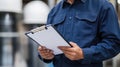 An engineer man making notes on his clipboard in a factory. Concept of Industry Royalty Free Stock Photo
