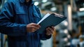 An engineer man making notes on his clipboard in a factory. Concept of Industry Royalty Free Stock Photo