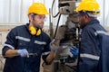 Engineer man training with foreman for apprentice using lathe, apprenticeship teaching with worker.