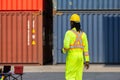 Engineer man walking in industry containers cargo, Foreman dock worker in hard hat at shipping container yard Royalty Free Stock Photo