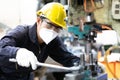Engineer man wearing face mask for protect virus, using wrench to fix the machine