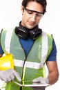 Engineer man working on digital tablet computer at worksite. Handsome young industrial worker were safety glove, protective Royalty Free Stock Photo