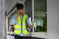 Engineer man in yellow vests having phone conversation while working in building construction site Royalty Free Stock Photo