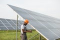 Engineer measuring amperage in solar panels outdoors