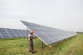 Engineer measuring amperage in solar panels outdoors