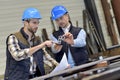 Engineer with mechanical worker checking on production quality Royalty Free Stock Photo