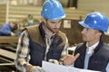 Engineer with mechanical worker checking on production quality Royalty Free Stock Photo