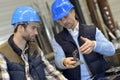 Engineer with mechanical worker checking on quality products Royalty Free Stock Photo