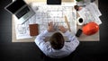 Engineer nervously checking drawings before beginning of building construction Royalty Free Stock Photo