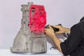 Engineer or operator who emits pink light laser from a portable 3d scan high accuracy equipment to a transmission block of