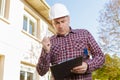 Engineer outdoors checking clipboard Royalty Free Stock Photo