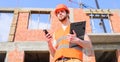 Engineer phone call control process. Contractor control according to plan. Guy protective helmet stand in front of