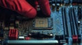 Engineer placing cpu on motherboard, working with microelectronics