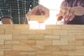 Engineer placing wooden block wall, Planning of project building construction