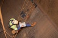 Engineer planer working at height abseiling into the chute, writing, drawing defected, faulty, damage liners his planning book