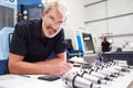 Engineer Planning Project With CNC Machinery In Background Royalty Free Stock Photo