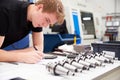 Engineer Planning Project With CNC Machinery In Background Royalty Free Stock Photo