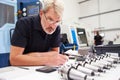 Engineer Planning Project With CNC Machinery In Background Royalty Free Stock Photo