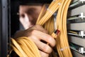 Engineer Plugging Cables Into Server