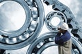 Engineer pointing at ball-bearings and chains Royalty Free Stock Photo