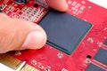 Engineer pulling the graphic processing unit GPU on the graphics card adapter VGA.GPU and electronic components on Red printed Royalty Free Stock Photo