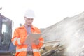 Engineer reading clipboard at construction site Royalty Free Stock Photo
