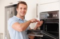 Engineer Reapiring Domestic Oven In Kitchen Royalty Free Stock Photo